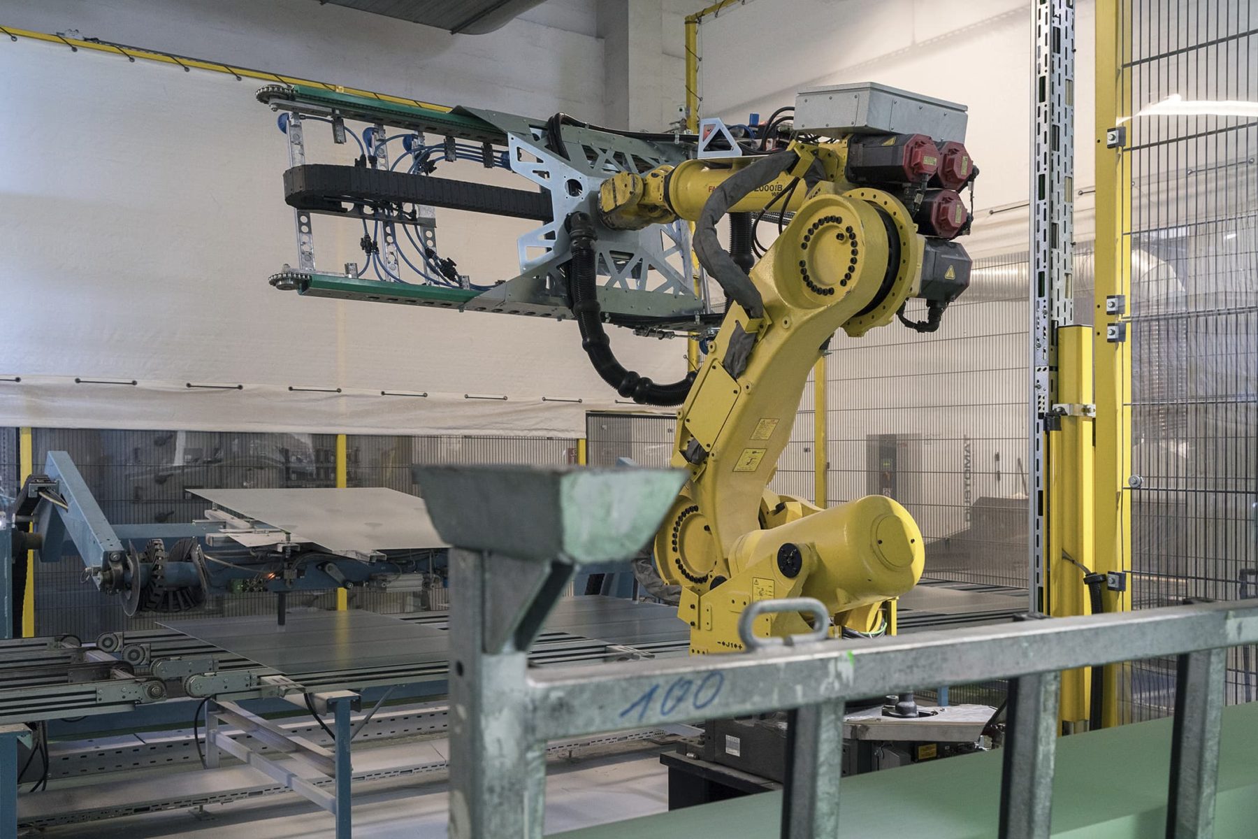 gelber Roboterarm mit Haltevorrichtung für Glasscheiben